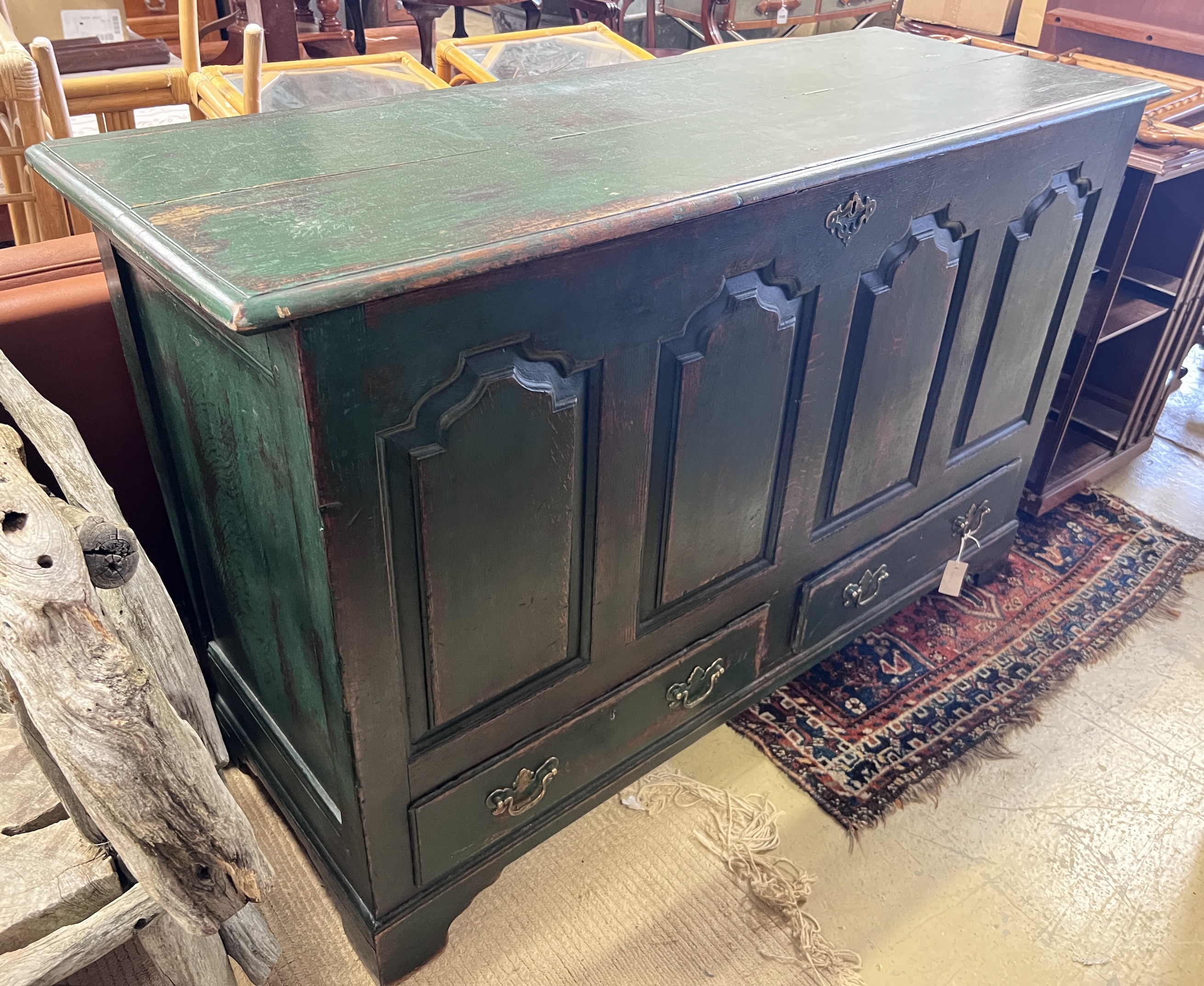 An 18th century panelled oak mule chest with later green paintwork, width 150cm, height 95cm